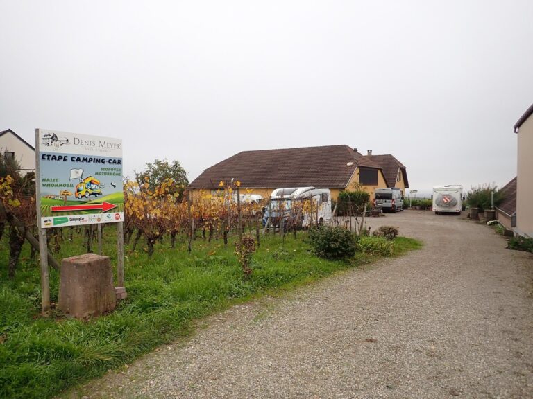 Motorhomes parked at a winery stopover beside vineyards in Alsace, France, the kind of overnight stay at the heart of the Harvest Hosts acquisition