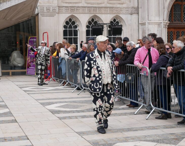 Pearlies in mother-of-pearl button suits at the 2024 Pearly Kings and Queens Harvest Festival in London, the tradition the Pearly King of Peckham, George Major, championed