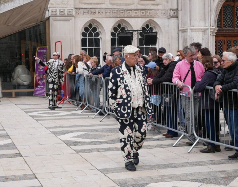Pearlies in mother-of-pearl button suits at the 2024 Pearly Kings and Queens Harvest Festival in London, the tradition the Pearly King of Peckham, George Major, championed