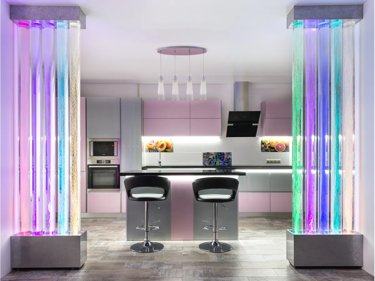 Spacious modern kitchen with creative lighting, colorful design elements, and the spotless, organized finish clean freaks can’t resist.