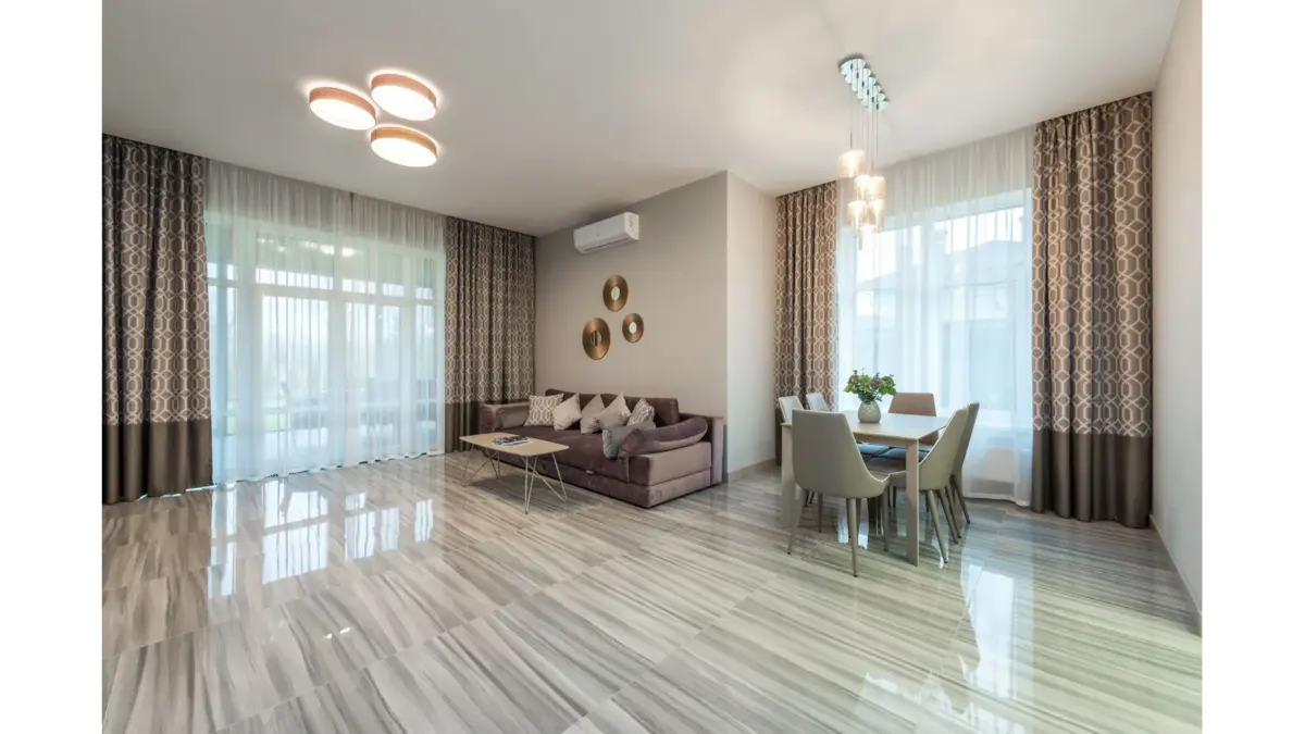 Spacious living room with contemporary décor, bright natural lighting, and the spotless, organized touch clean freaks absolutely love.