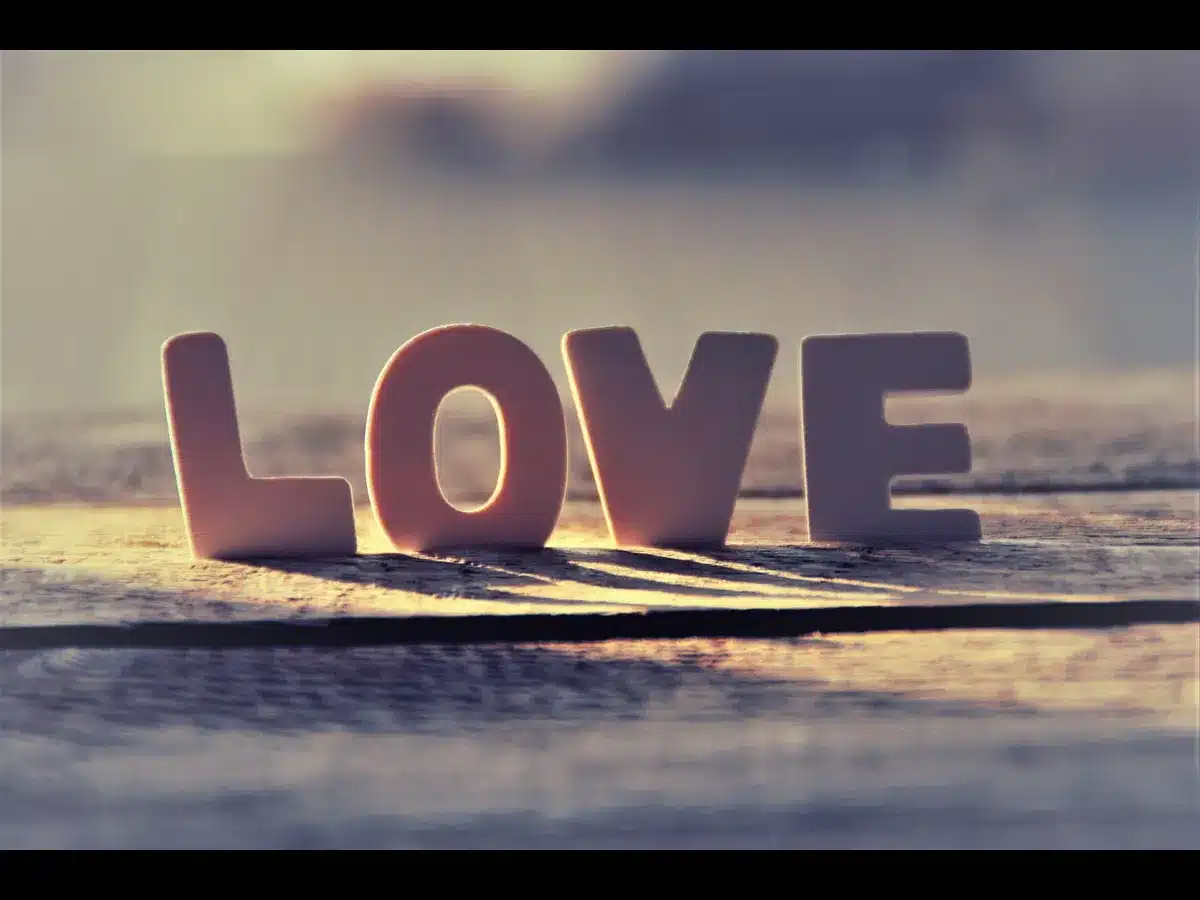 In Friday's daily devotional, "Love" is spelled out in large pink letters on a grounded surface.