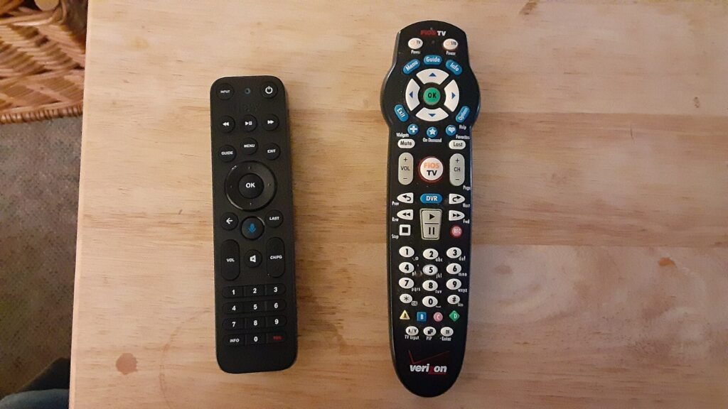 Two Verizon Fios TV remote controls on a wooden table, the service hit by the Starz Fios blackout